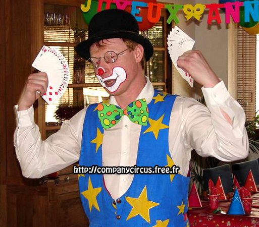 Le public adore la magie et des tours des cartes interactifs du clown magicien